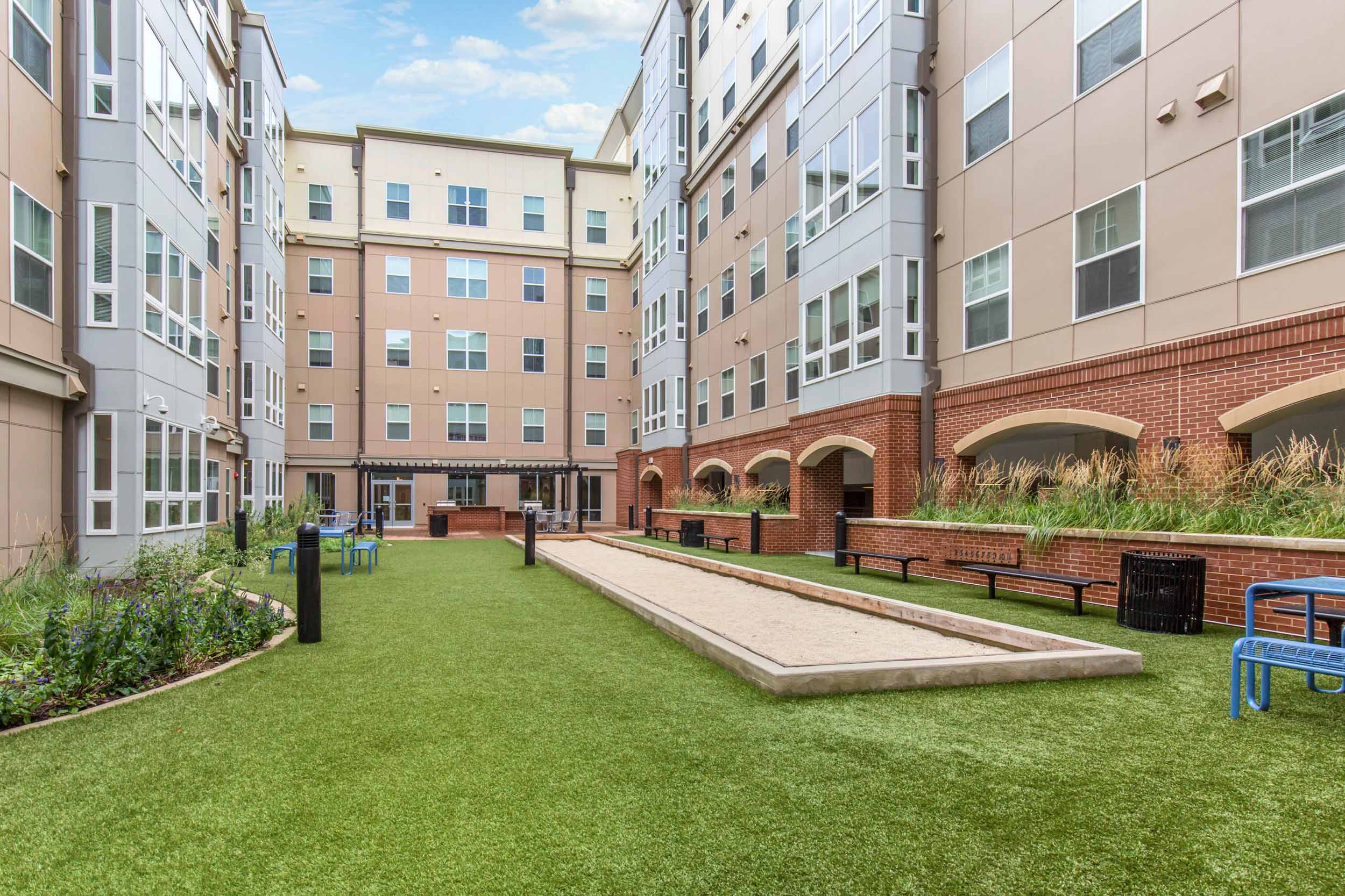 community 5 courtyard terrace grass buildings blue sky outdoor game area and grilling station