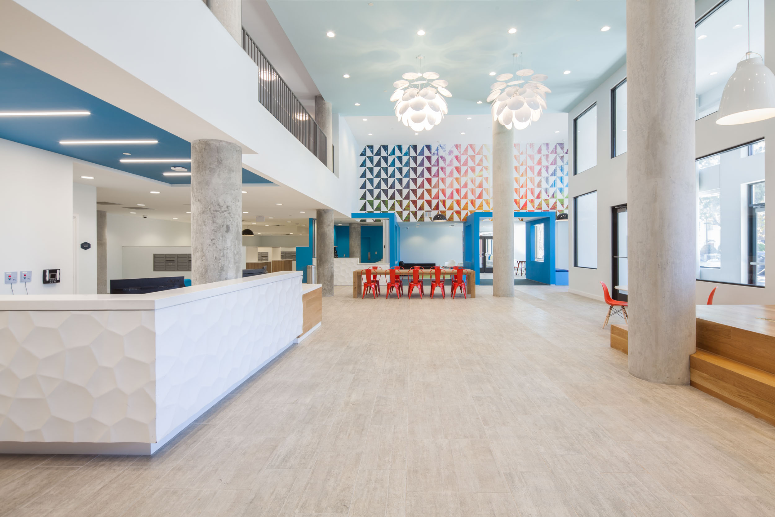 community 13 landmark college park red chairs wood table stairs leading up to corridor tall ceilings front entrance