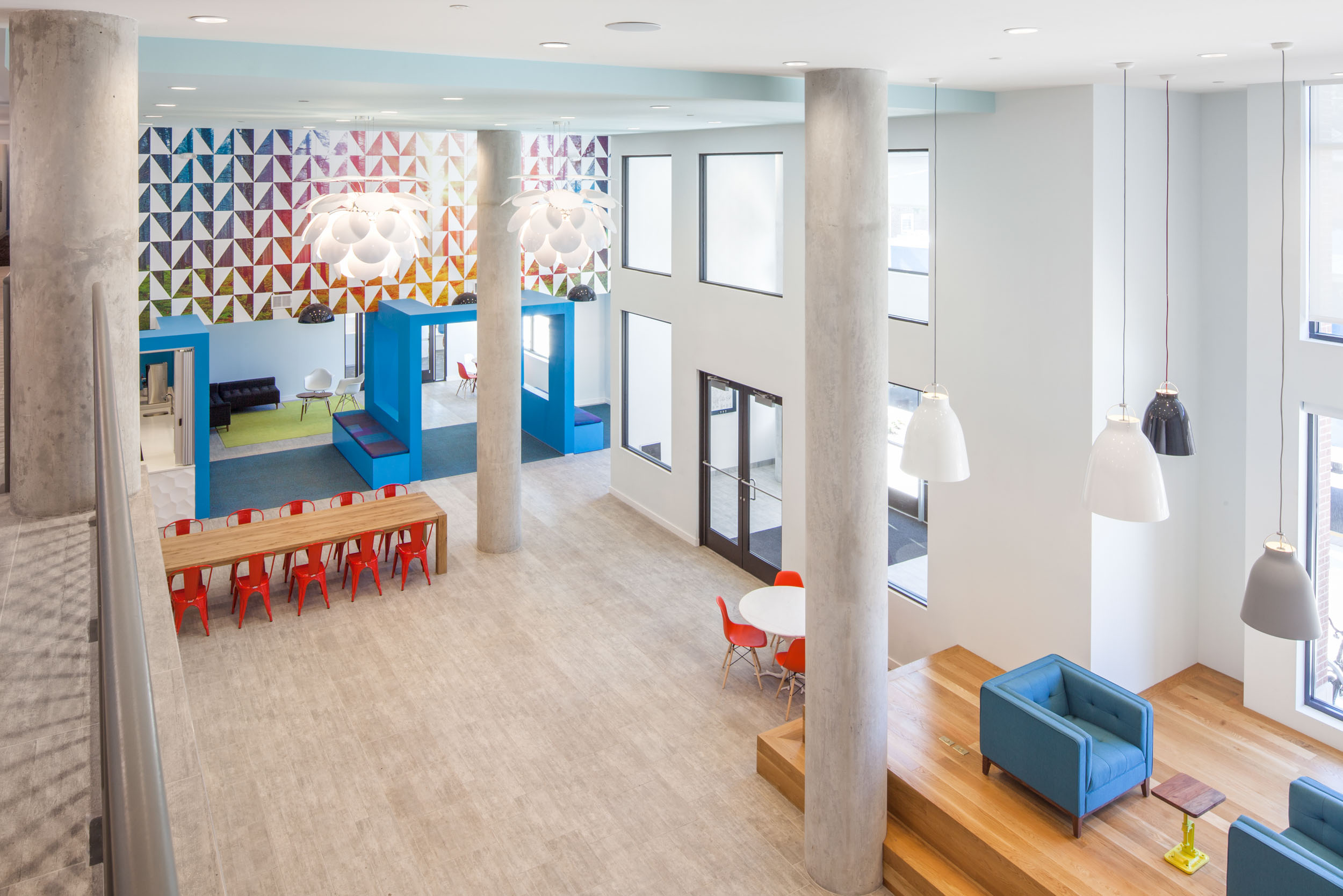 community 19 landmark college park red chairs wood table stairs leading up to corridor tall ceilings front entrance