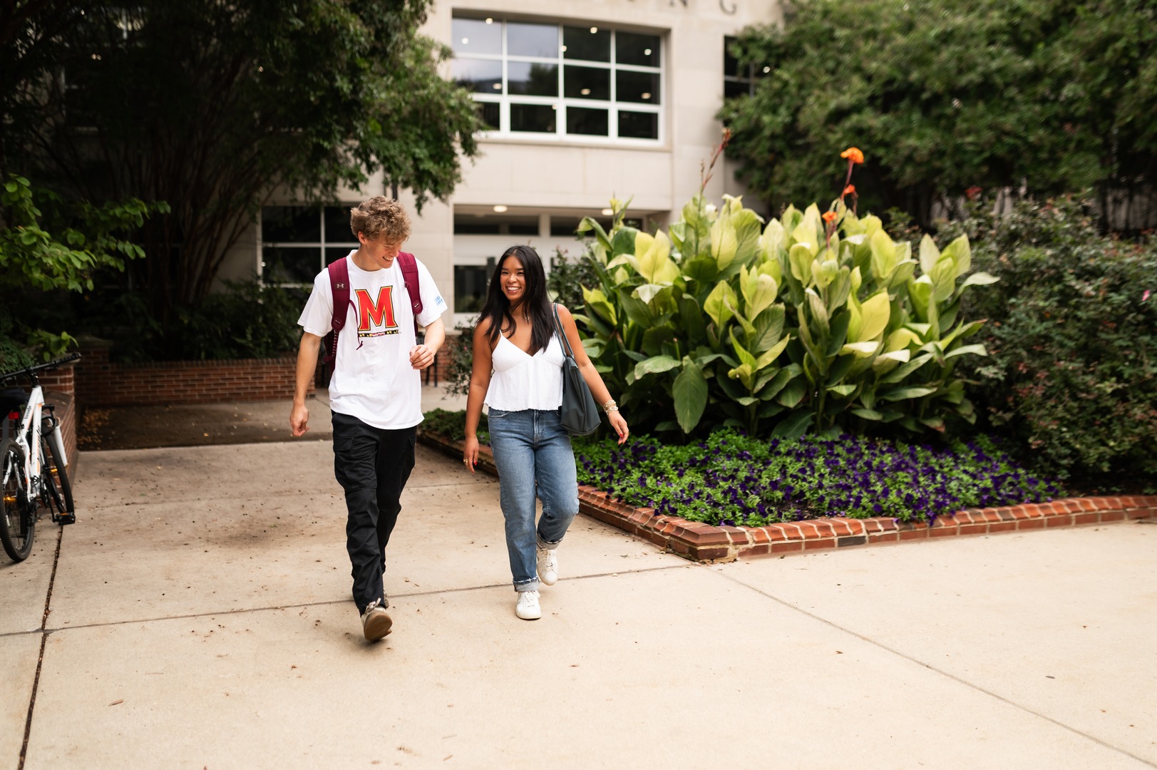 two students walking around campus near landmark college park