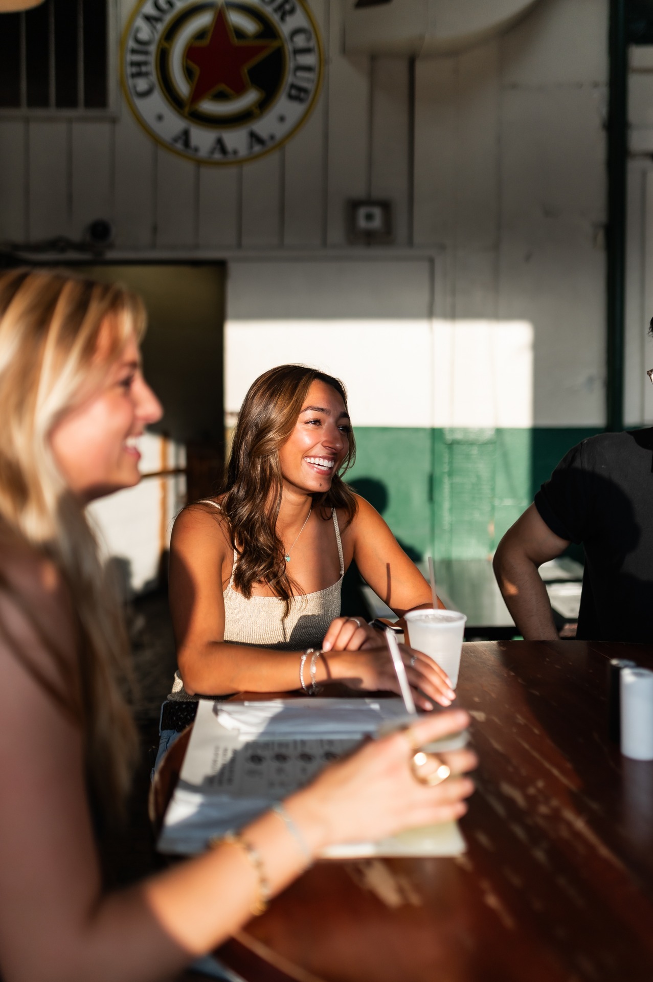 two girls talking while sitting and studying in study area at landmark college park