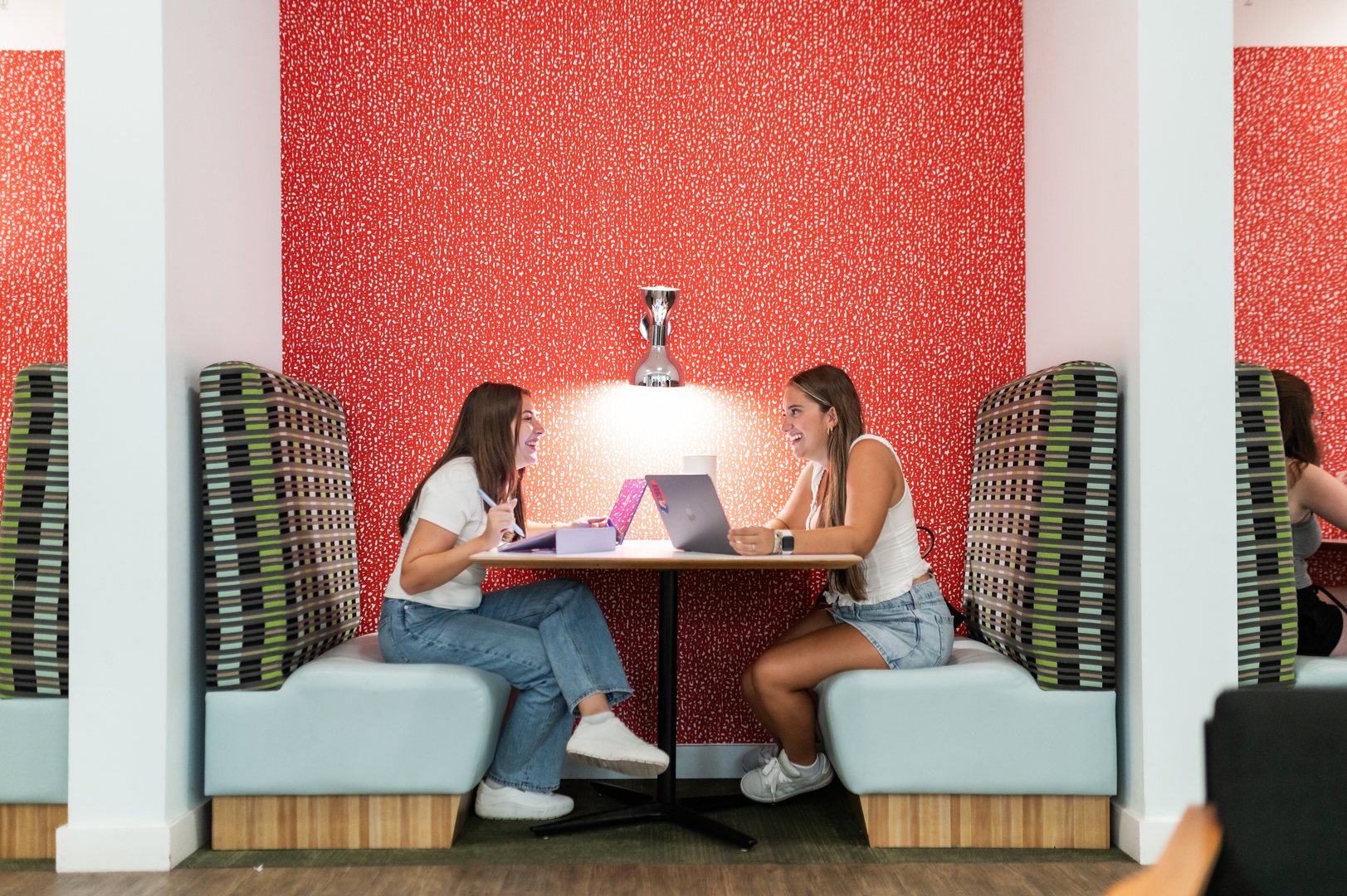two girls studying and talking in the study louge at landmark college park