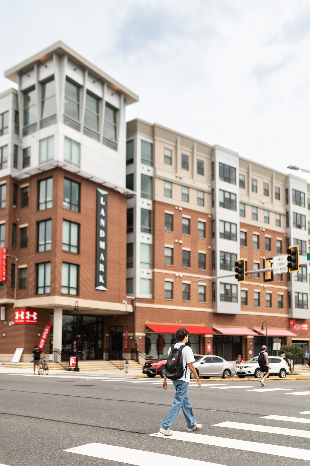 outside exterior of landmark college park during daytime cars and people roaming around building