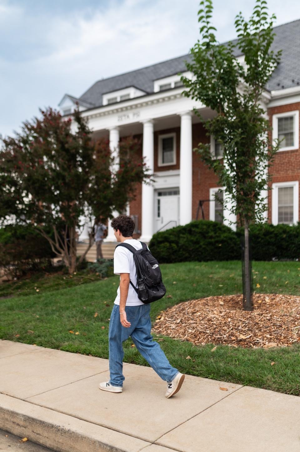 Student walking on Fraternity Row, a popular spot on UMD’s campus. 