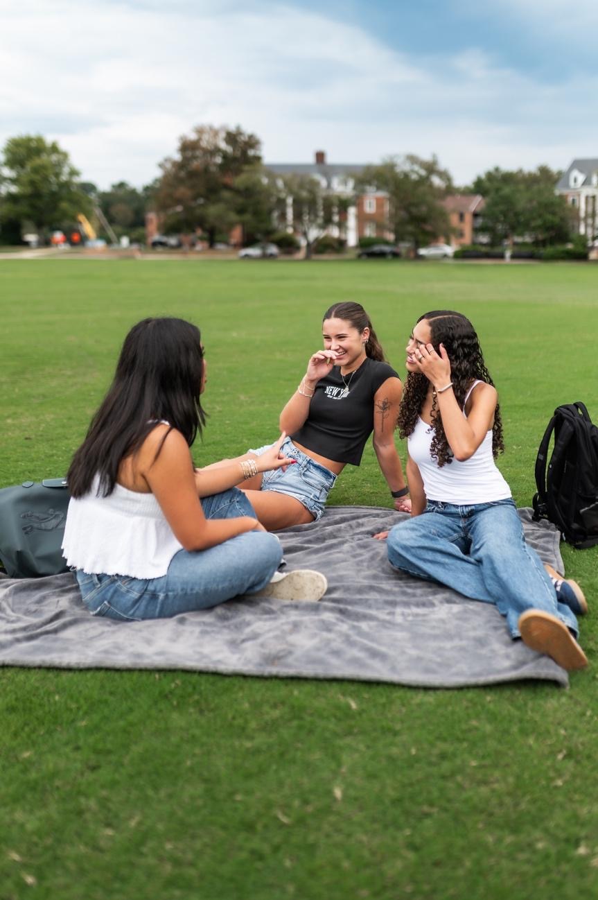 Students hanging out on Fraternity Row fields. 